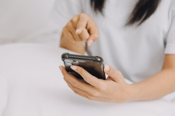 Young adult happy smiling Hispanic Asian student wearing headphones talking on online chat meeting using laptop in university campus or at virtual office. College female student learning remotely.