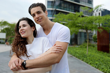 Man and woman couple smiling confident hugging each other at street