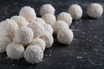 photo of coconut-flavored candy balls lying on a dark background
