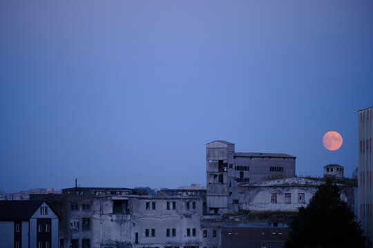 A big, beautiful moon over a ruined factory in Ukraine