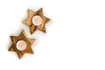Wooden candlesticks in the shape of star on white background with space for text. Shabbat Shalom. Top view, flat lay
