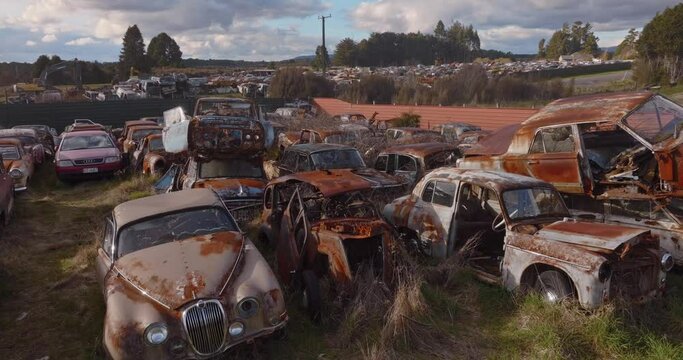 Aerial: Abandoned junk rusted cars in junkyard, New Zealand