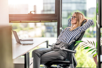 Relax at work. A young woman is relaxing in the office. End of the working week. - 630826536