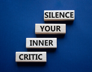 Silence your inner critic symbol. Wooden blocks with words Silence your inner critic. Beautiful deep blue background. Business and Silence your inner critic concept. Copy space.