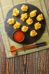 Traditional Chinese  Shrimp shumai Open-topped dumpling filled with chopped shrimp, closeup on the table. Vertical top view from above