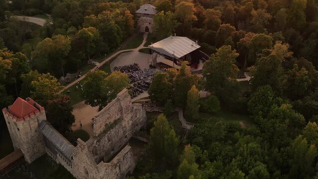 Sigulda Castle at sunset. Opera days on the palace stage. Park of the ancient Sigulda Castle