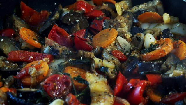 Vegetable dinner. Cook vegetable stew in a skillet. Fresh vegetables in a salad. Chopped eggplant, bell peppers, tomatoes.