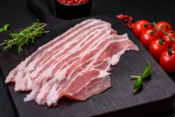 Fresh raw bacon cut into slices with salt, spices and herbs