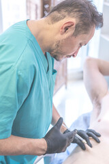 Latin doctor injecting anesthesia to patient on operating table