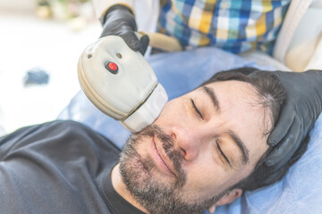 Latino man getting cosmetic treatment on his face