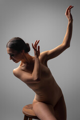 Professional female contemporary dancer in studio on gray background