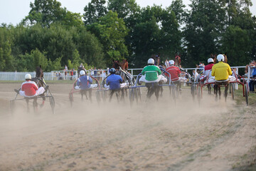 Yadrin, Chuvashia, Russia - August 13, 2022 : Horses and riders running at horse races