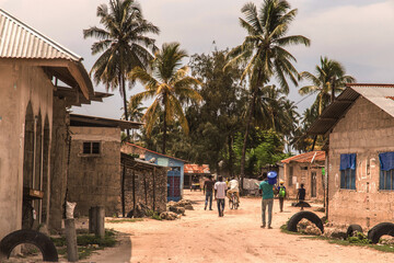 traditional African road through the village and people going about their business
