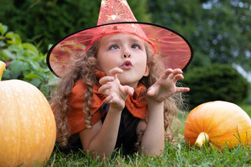halloween kids. portrait happy girl in witch costume, black hat on scary merry holiday. child with pumpkin, jack o lantern, basket candy sweet, scaring boo