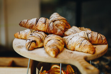 Close up of Tasty Croissants on wooden board