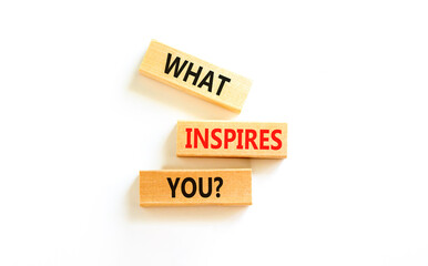 What inspires you symbol. Concept words What inspires you on wooden block. Beautiful white table white background. Business motivational what inspires you concept. Copy space.