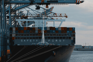 Antwerp, Belgium - 06 29 2023: LNG Powered large container vessel with a huge sign on her bow....