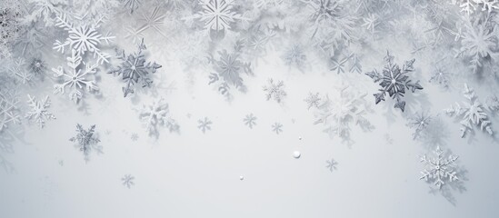 A Christmas picture made up of snowflakes on a pale gray background. Represents the winter season. Photographed from above with the frame laid out and room for text.
