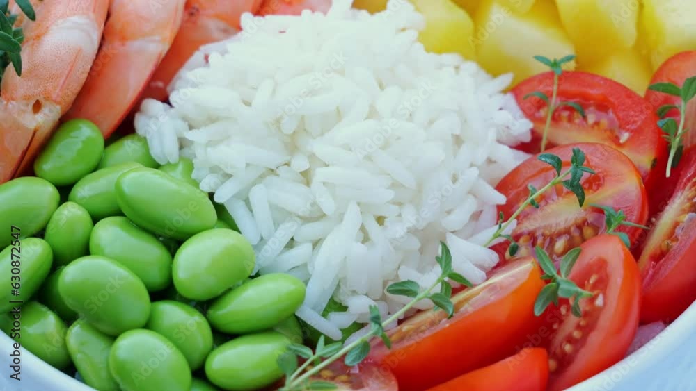 Poster poke bowl with shrimp, prawn, rice, edamame beans, mango, tomato, circling on table. healthy food.