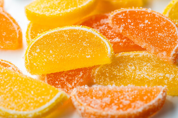 Marmalade lemon slice sprinkled with sugar, on a white background, macro.