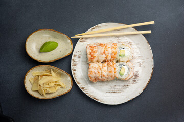 Philadelphia roll with shrimp and avocado. Black background. Close up 