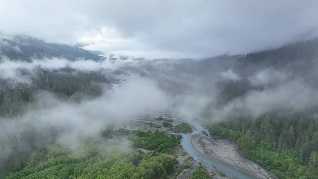 Rain clouds drift over the Hoh river flowing through one of the largest temperate rainforests in the U.S. Receiving over 100 inches of rain annually, the Olympic Peninsula is lush with flora.