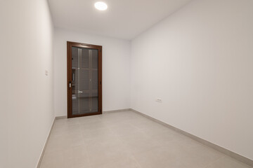 Empty bright room with a panoramic glass door leading to a balcony. The concept of renting housing in a new building or an apartment after renovation