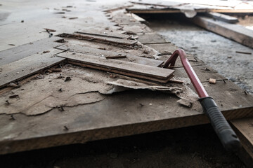 dismantling the floor parquet loft retro construction work crowbar hammer, close-up