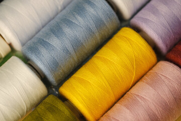 pink, orange, yellow, red, brown, green, blue, lilac, white sewing thread on spools, natural,...