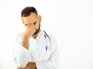 Young stressed male doctor having a headache. Isolated on white background