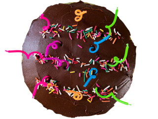 Festive birthday cake with colorful sprinkles and candles