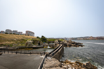 Open tanks of La Coruna aquarium in front of the city seafront and beach areas.