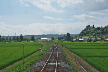 Fototapeta na wymiar Akita, Japan - July 28, 2023: Single-track railway in rural zone in Akita, Japan 