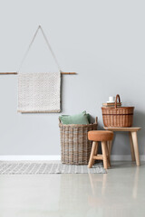 Interior of light living room with wicker baskets