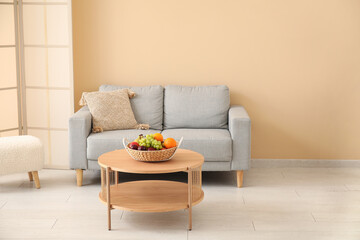 Interior of living room with sofa and fruit basket on table