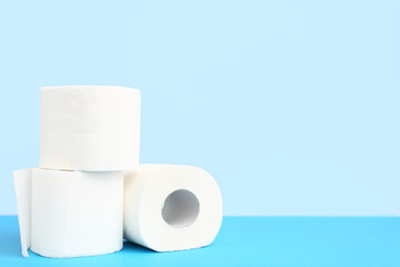 Rolls of toilet paper on blue background
