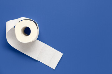 Roll of toilet paper on blue background