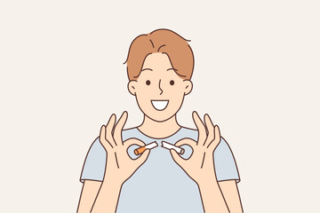 Man quit smoking breaks cigarette and recommends giving up use of nicotine and tobacco