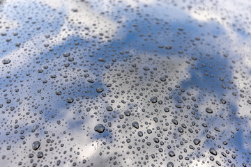 Raindrops on Car Hood with Reflection of the Sky