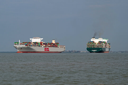 Ship traffic in Charleston Harbor, SC, USA; outbound OOCL container ship Chongoing passes the inbound cargo vessel Evergreen Forward on August 3, 2023.