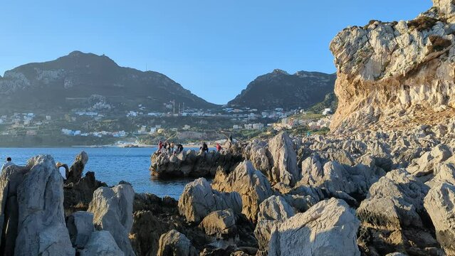 Fishing in the Mediterranean Ocean. A sunny day in Belyounech, Morocco. Blue sky with a clear view, Africa.
