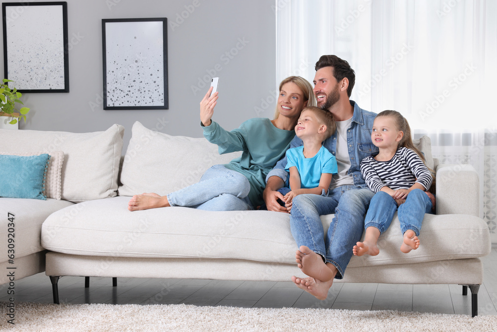 Canvas Prints Happy family taking selfie together on sofa at home