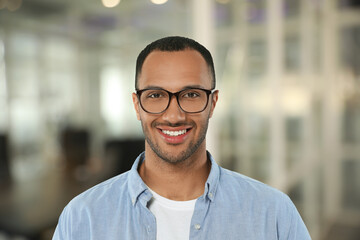 Handsome confident man with eyeglasses in office