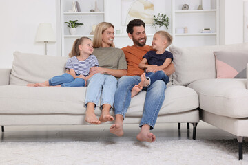 Happy family spending time together on sofa at home