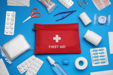 Flat lay composition with first aid kit on light blue background