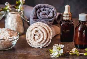 Garden poster Spa Beauty spa treatment and relax concept. Towel, sea salt and essential oils on a dark background
