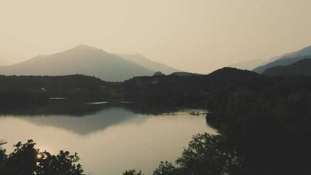 Sunset reveal shot of Lake Sirio near morainic town of Ivrea