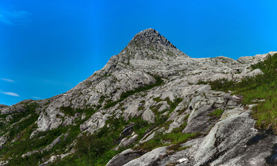 Panorama from below Smaltinden, Luröy, Helgeland, Nordnorge. Northern Norway peak. Smaltindan. Rocks leading up to narrow mountain peak. Norwegian hiking. Discover Norway. Backpacking in Helgeland. 