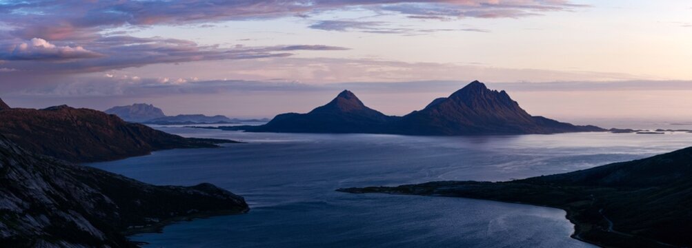 Panorama of dusk over Tomma island, Helgeland, Nordnorge. Twilight light from Smaltinden, Lur&ouml;y. Midnight light over norwegian archipelago on the arctic coast. High resolution Norway mountain fjord. 