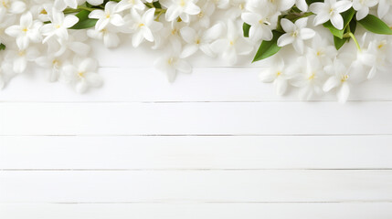 white spring flowers on white wooden background with empty space to insert